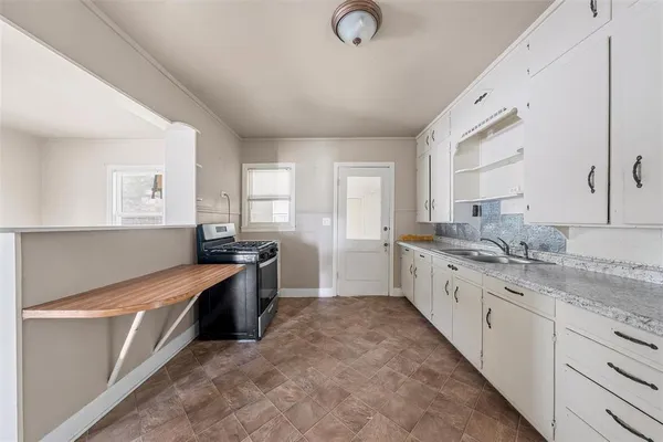 a large kitchen with a stove top oven
