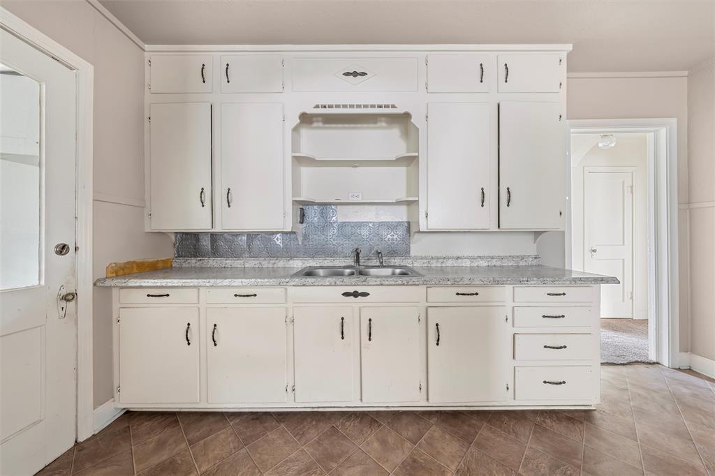731 Highway 320 Lott, TX 76656 - Photo 6 of 16 a bathroom with granite countertop white cabinets and sink