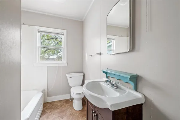 a bathroom with a sink toilet and a mirror