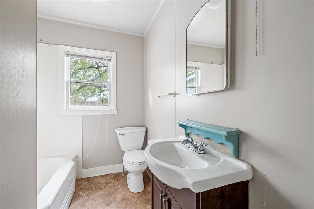 731 Highway 320 Lott, TX 76656 - Photo 9 of 16 a bathroom with a sink toilet and a mirror