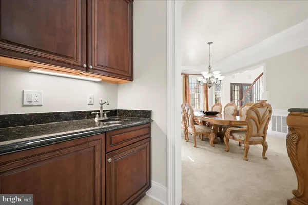 a kitchen with stainless steel appliances granite countertop wooden cabinets a stove a sink and a refrigerator