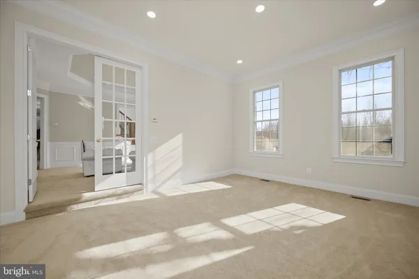 a kitchen with stainless steel appliances granite countertop wooden cabinets a stove a sink and a large window