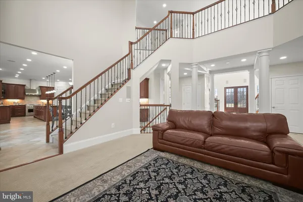 a view of a hallway with wooden floor and stairs
