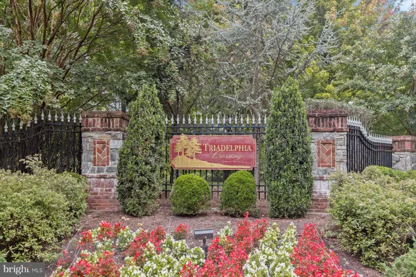 a view of staircase with lots of frames on wall and windows
