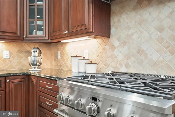 a bathroom with a granite countertop sink toilet and mirror