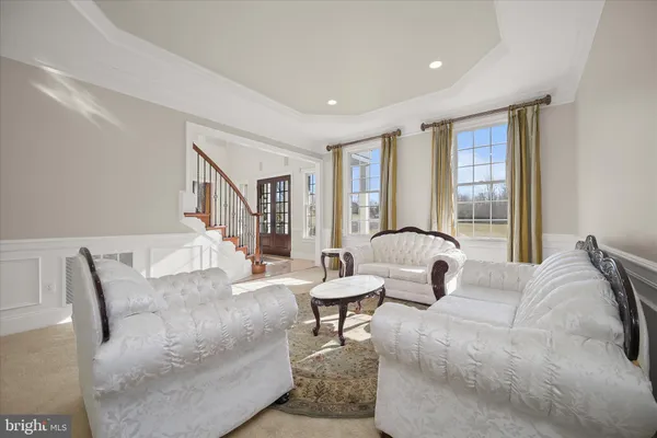 a dining room with furniture a chandelier and wooden floor
