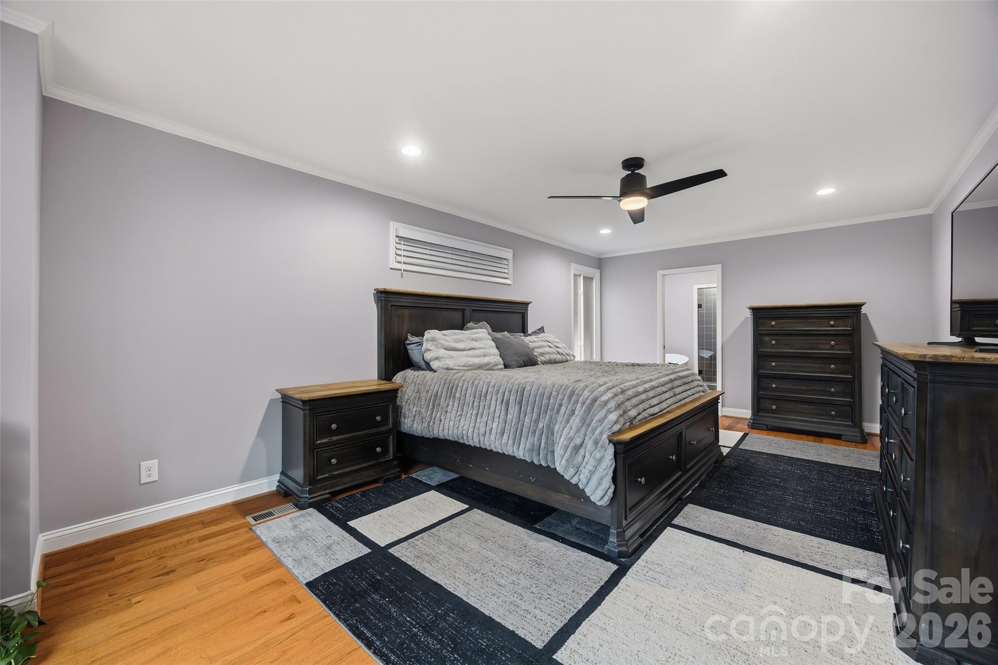 850 Burnley Road Charlotte, NC 28210 - Photo 14 of 38 a bed room with a bed and a ceiling fan