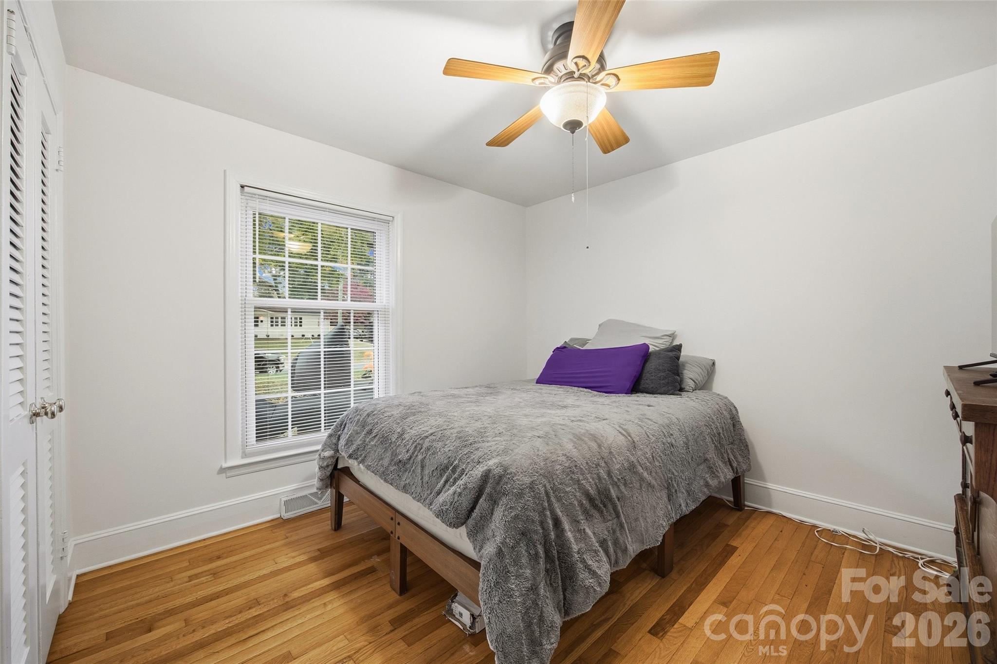 850 Burnley Road Charlotte, NC 28210 - Photo 19 of 38 a bedroom with a bed and a chandelier