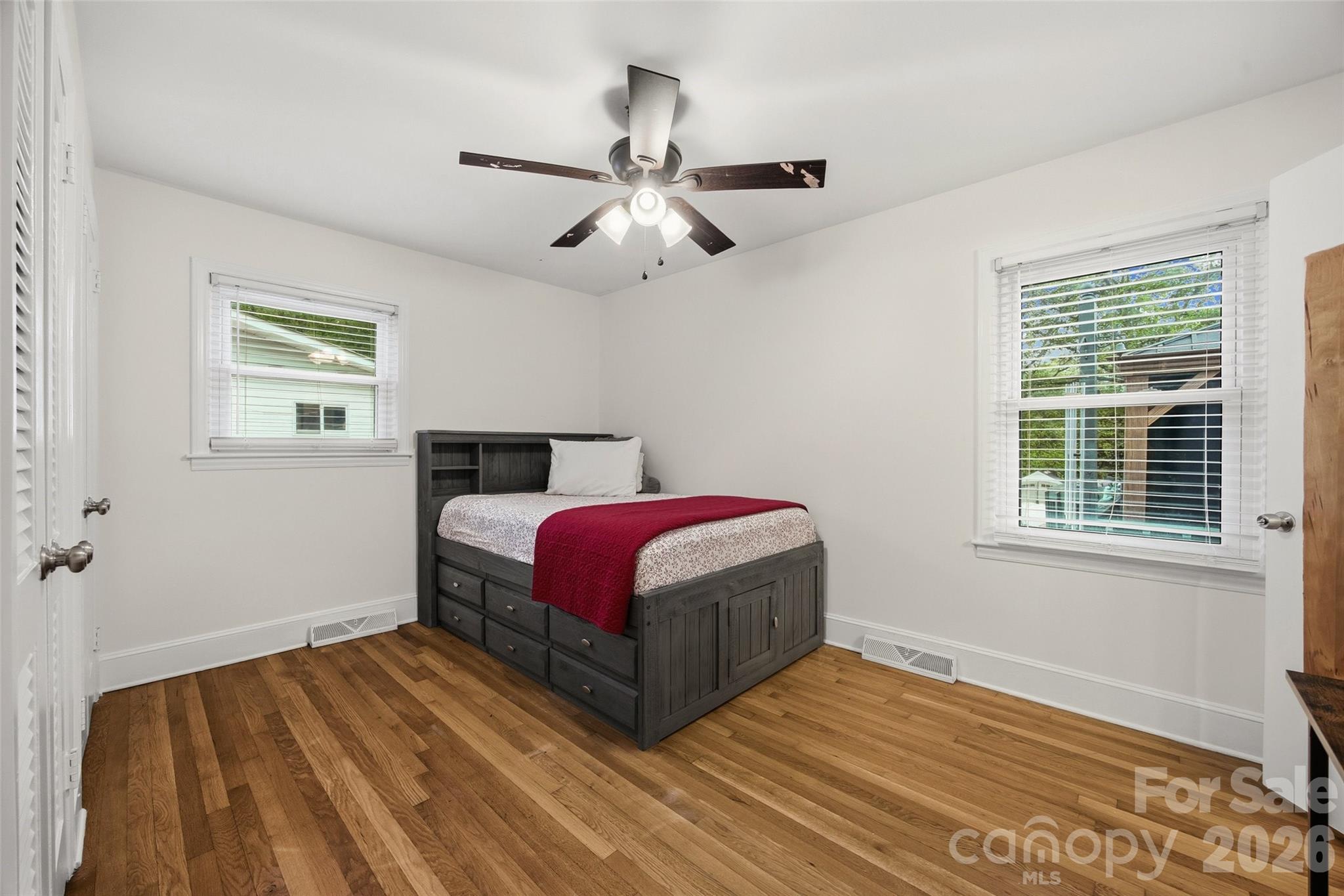 850 Burnley Road Charlotte, NC 28210 - Photo 21 of 38 a bedroom with a bed and wooden floor