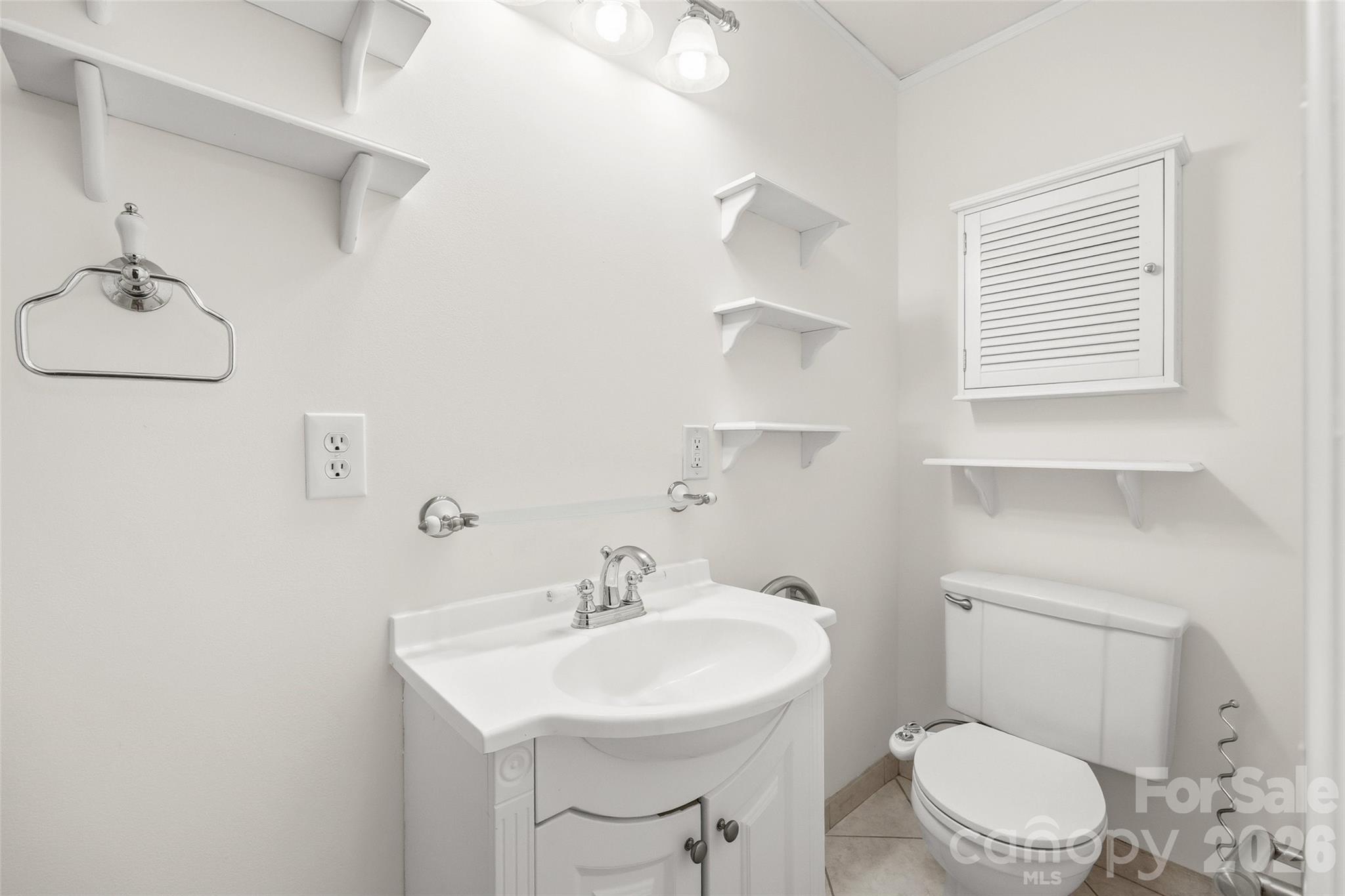 850 Burnley Road Charlotte, NC 28210 - Photo 22 of 38 a bathroom with a sink a toilet and a mirror