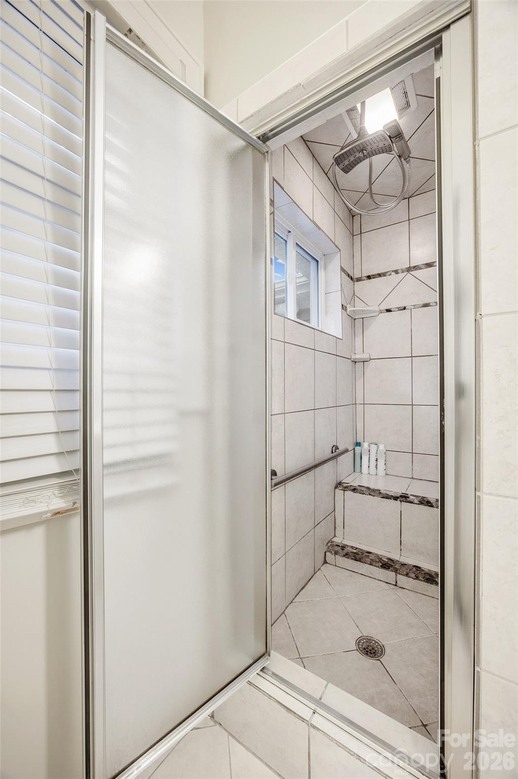 850 Burnley Road Charlotte, NC 28210 - Photo 23 of 38 a bathroom with a glass shower door