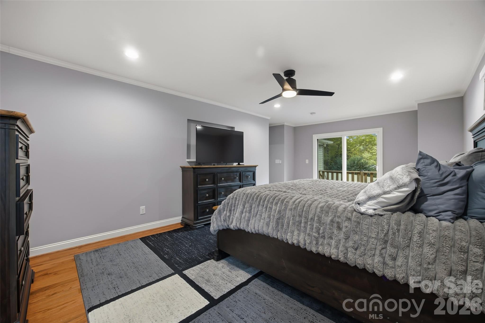 850 Burnley Road Charlotte, NC 28210 - Photo 4 of 38 a bedroom with a bed and a television