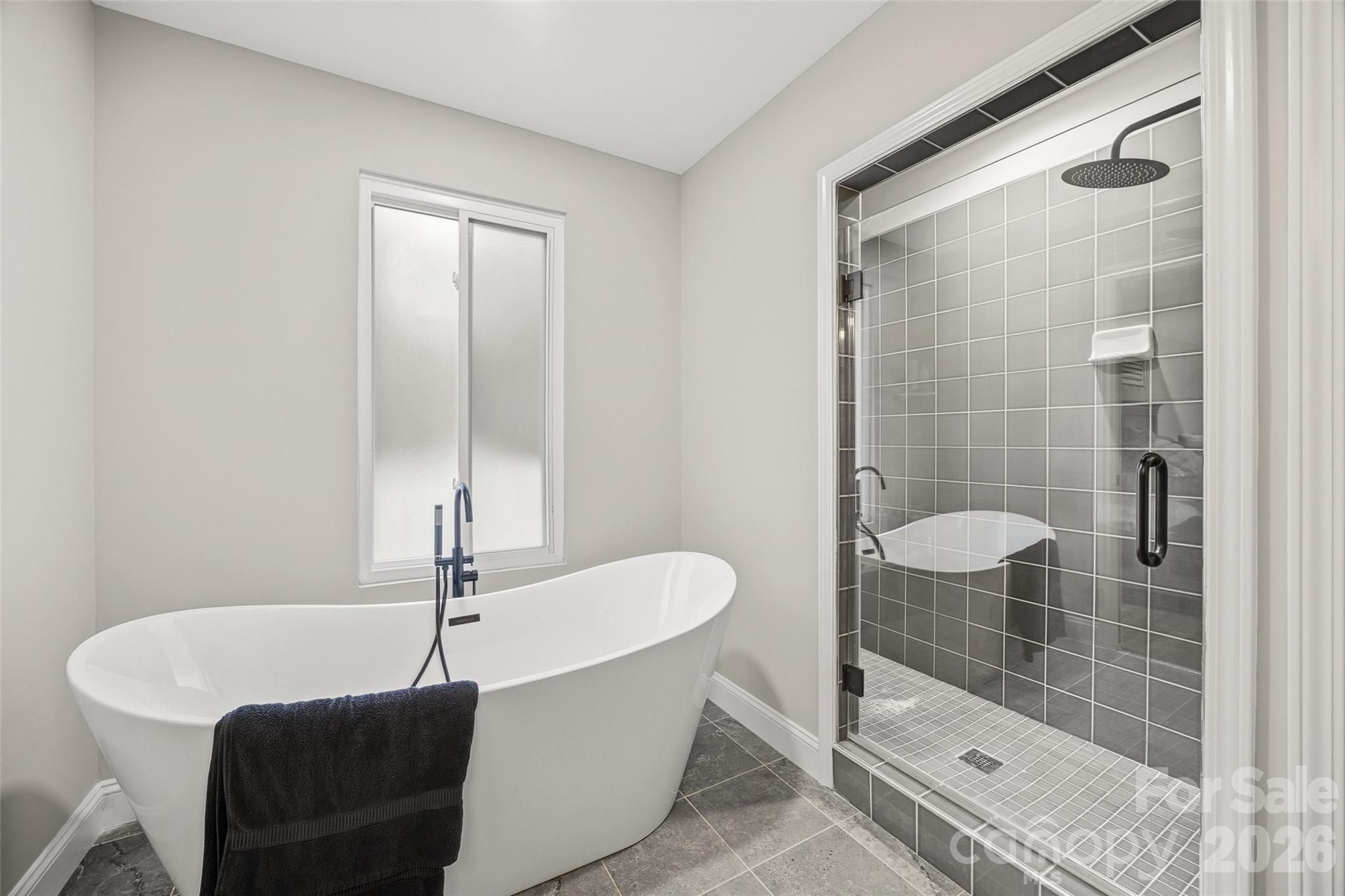 850 Burnley Road Charlotte, NC 28210 - Photo 5 of 38 a bathroom with a bathtub and a shower