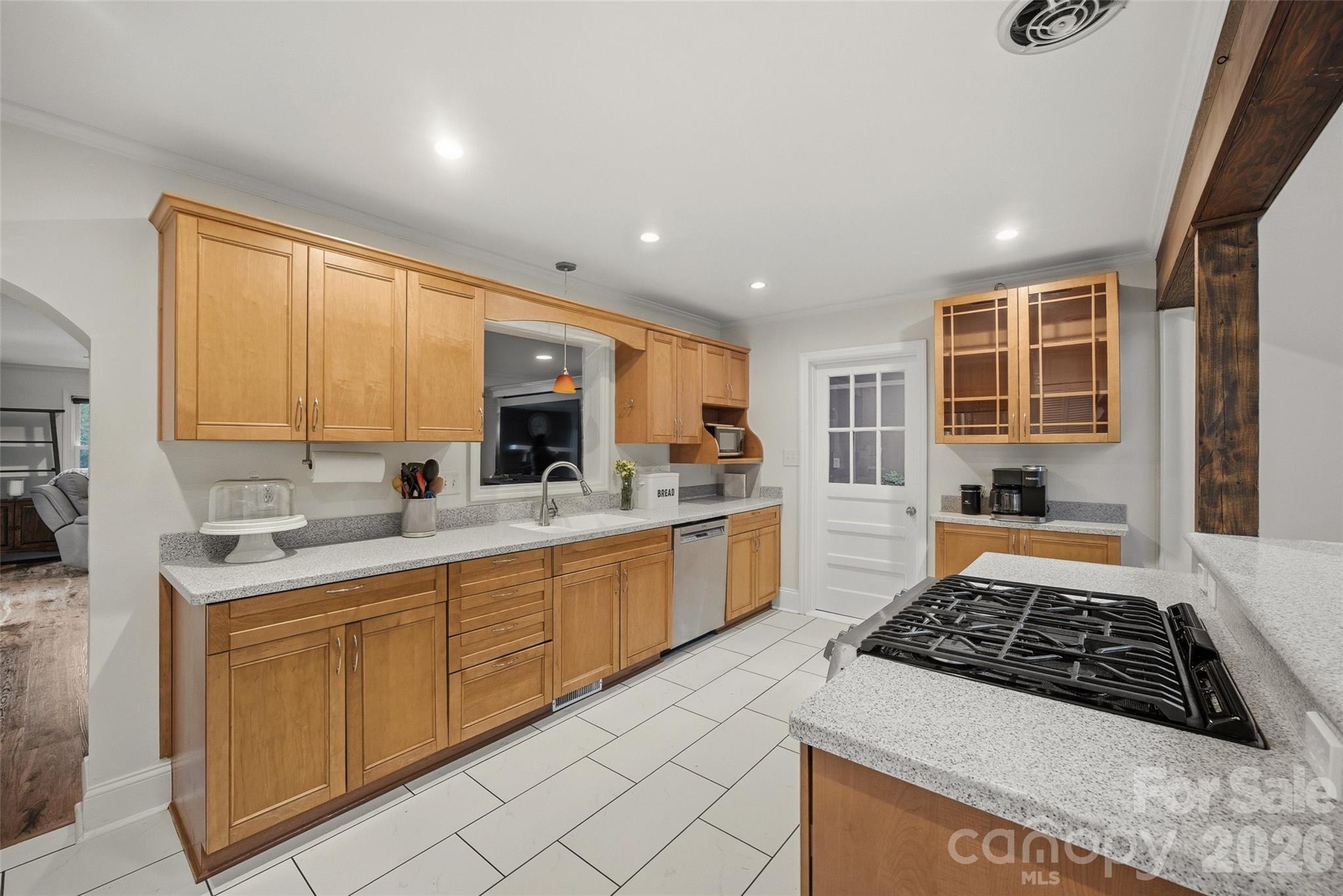 850 Burnley Road Charlotte, NC 28210 - Photo 9 of 38 a large kitchen with stainless steel appliances granite countertop a stove a sink and a microwave