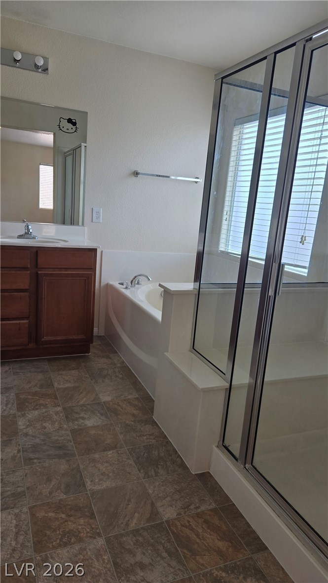 9031 Spring Star Court Las Vegas, NV 89148 - Photo 13 of 17 A well-appointed bathroom offers both a spacious soaking tub and a walk-in shower.