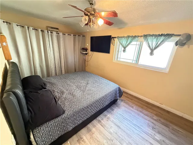 a bed sitting in a bedroom next to a window