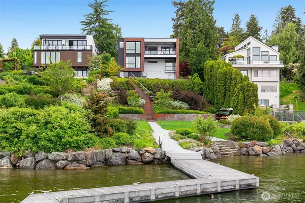 a view of a house with a yard and a pond