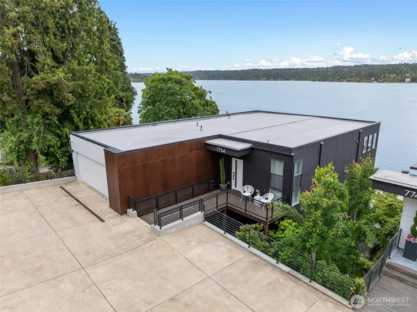a view of a terrace with a table and chairs under an umbrella