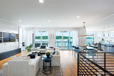 a living room with furniture and large windows