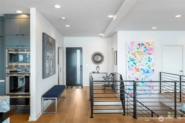 a living room with stainless steel appliances kitchen island granite countertop furniture and a kitchen view