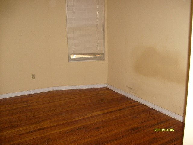 4810 South Prairie Avenue, Unit 2N Chicago, IL 60615 - Photo 11 of 15 a view of an empty room with wooden floor and a window