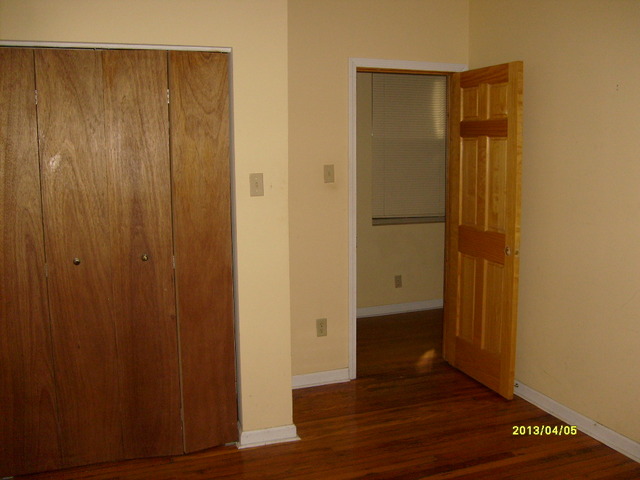 4810 South Prairie Avenue, Unit 2N Chicago, IL 60615 - Photo 12 of 15 an empty room with wooden floor