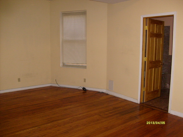4810 South Prairie Avenue, Unit 2N Chicago, IL 60615 - Photo 7 of 15 an empty room with wooden floor and closet