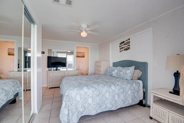 a living room with a bed and a television