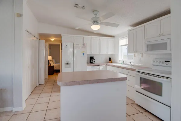 a kitchen with stainless steel appliances granite countertop a sink and cabinets