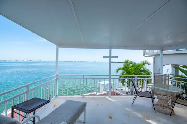 an aerial view of a house with garden space and ocean view