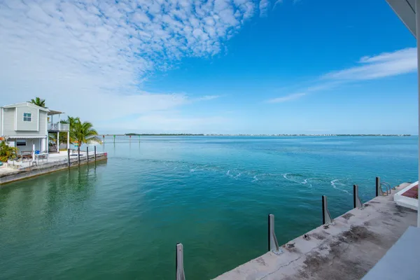an aerial view of a house with garden space and ocean view