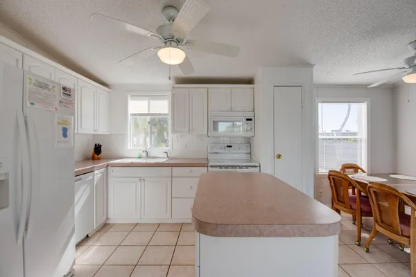 a kitchen with stainless steel appliances granite countertop a white cabinets and a refrigerator