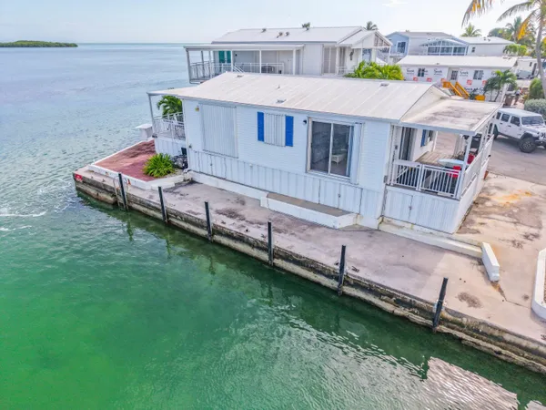 an aerial view of a house with a backyard
