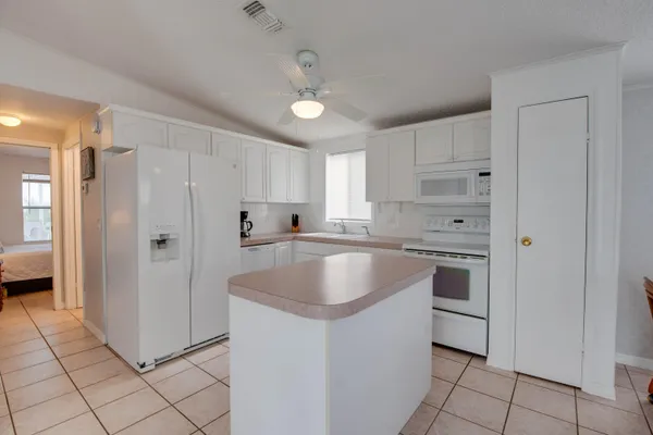 a kitchen with granite countertop a sink stove and refrigerator