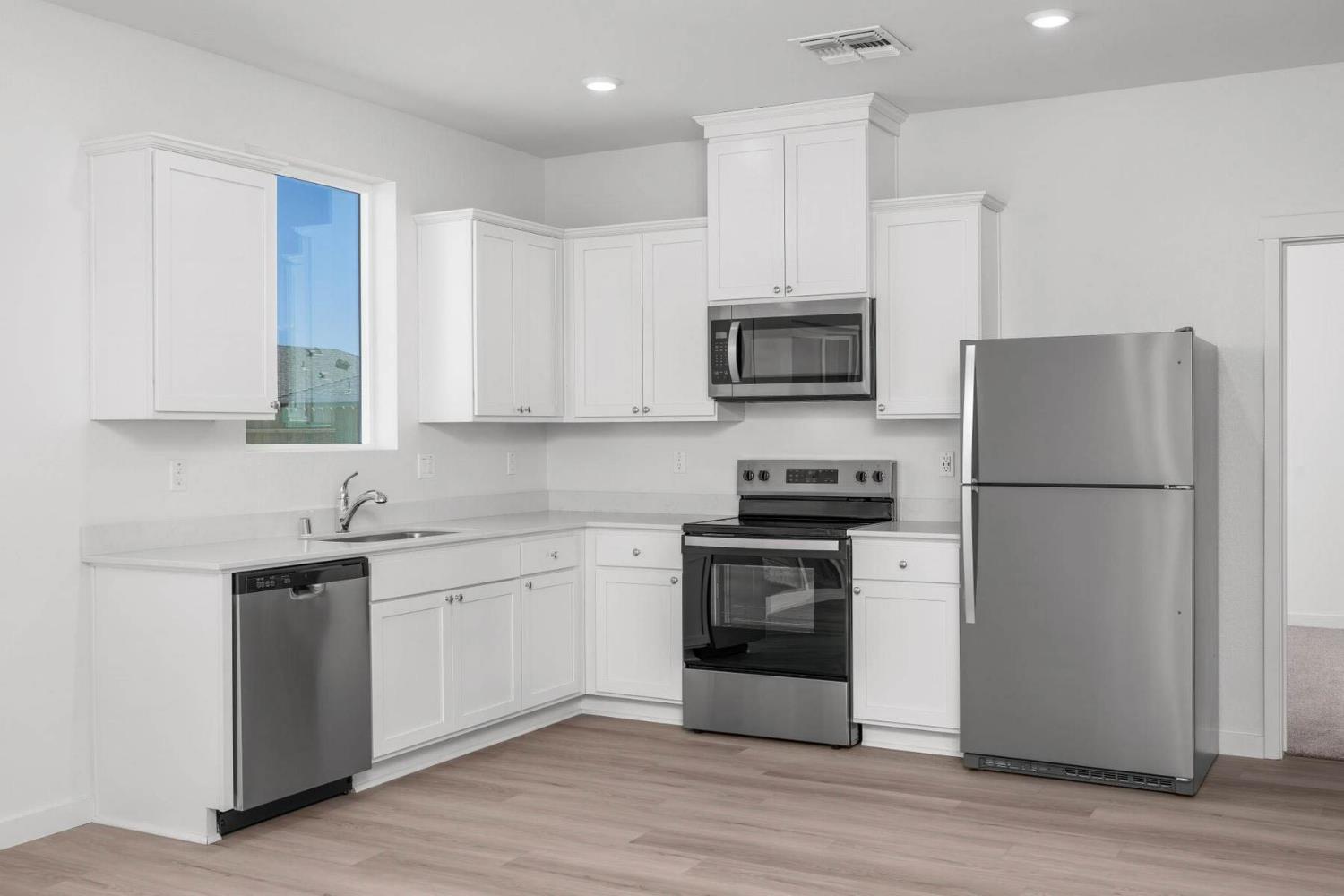 4972 Horner Avenue Stockton, CA 95215 - Photo 5 of 11 a kitchen with stainless steel appliances granite countertop a refrigerator stove a sink and a microwave