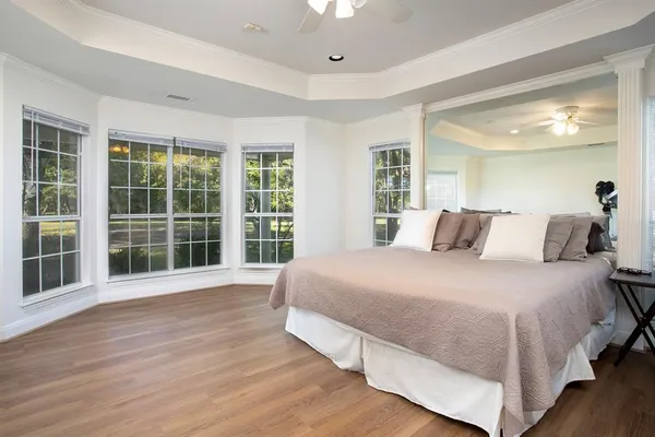 a spacious bedroom with a large bed and a large window