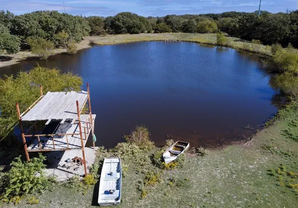 an aerial view of a house with a lake view