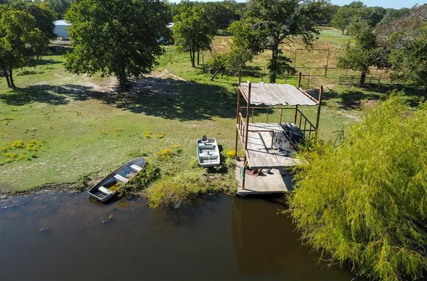 an aerial view of a house with a yard basket ball court and outdoor seating