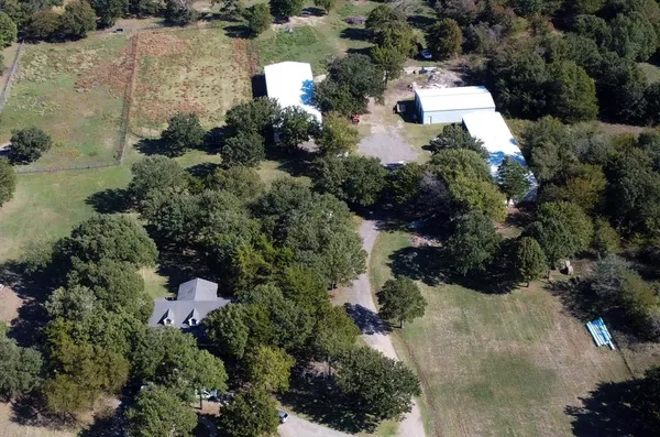 an aerial view of a house with a yard