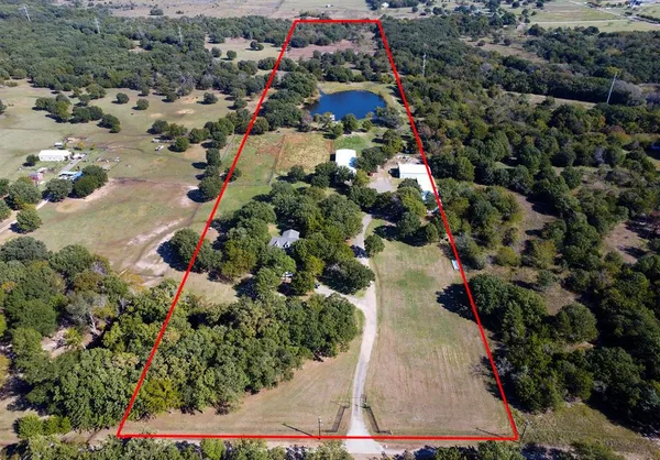 an aerial view of residential house with outdoor space and lake view