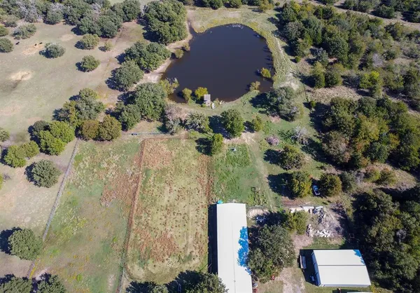 an aerial view of house with yard and lake view