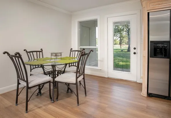 a view of a dining room with furniture and wooden floor