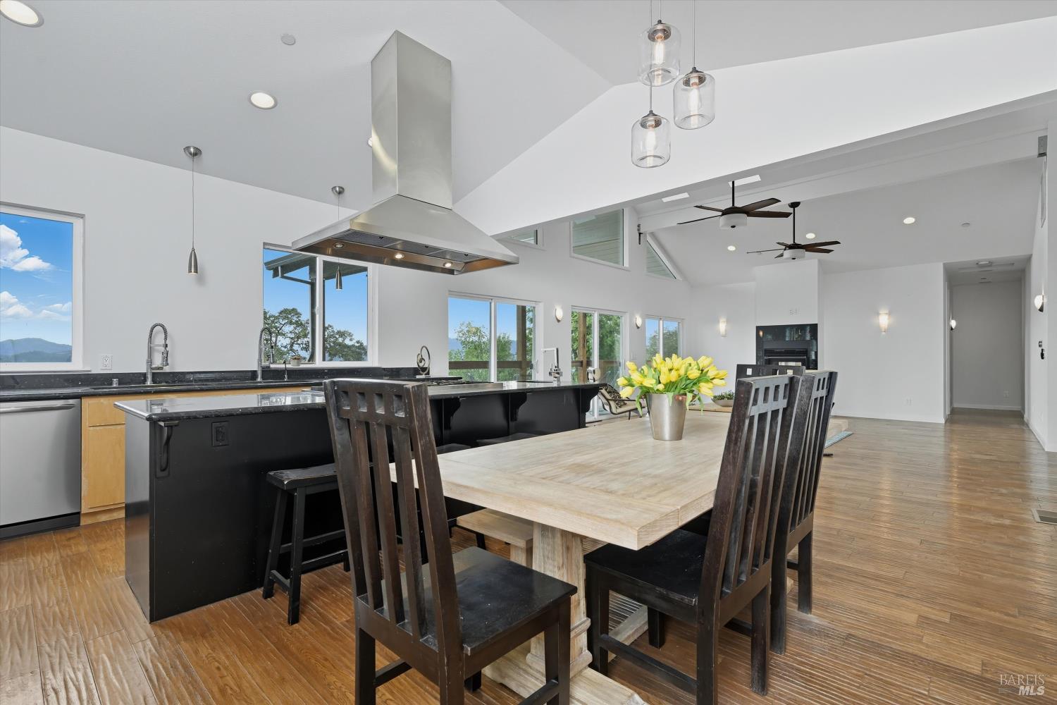 31000 Pine Mountain Road Cloverdale, CA 95425 - Photo 24 of 61 Dining area positioned beside expansive windows invites relaxed meals with views of surrounding oaks and hillside landscape.