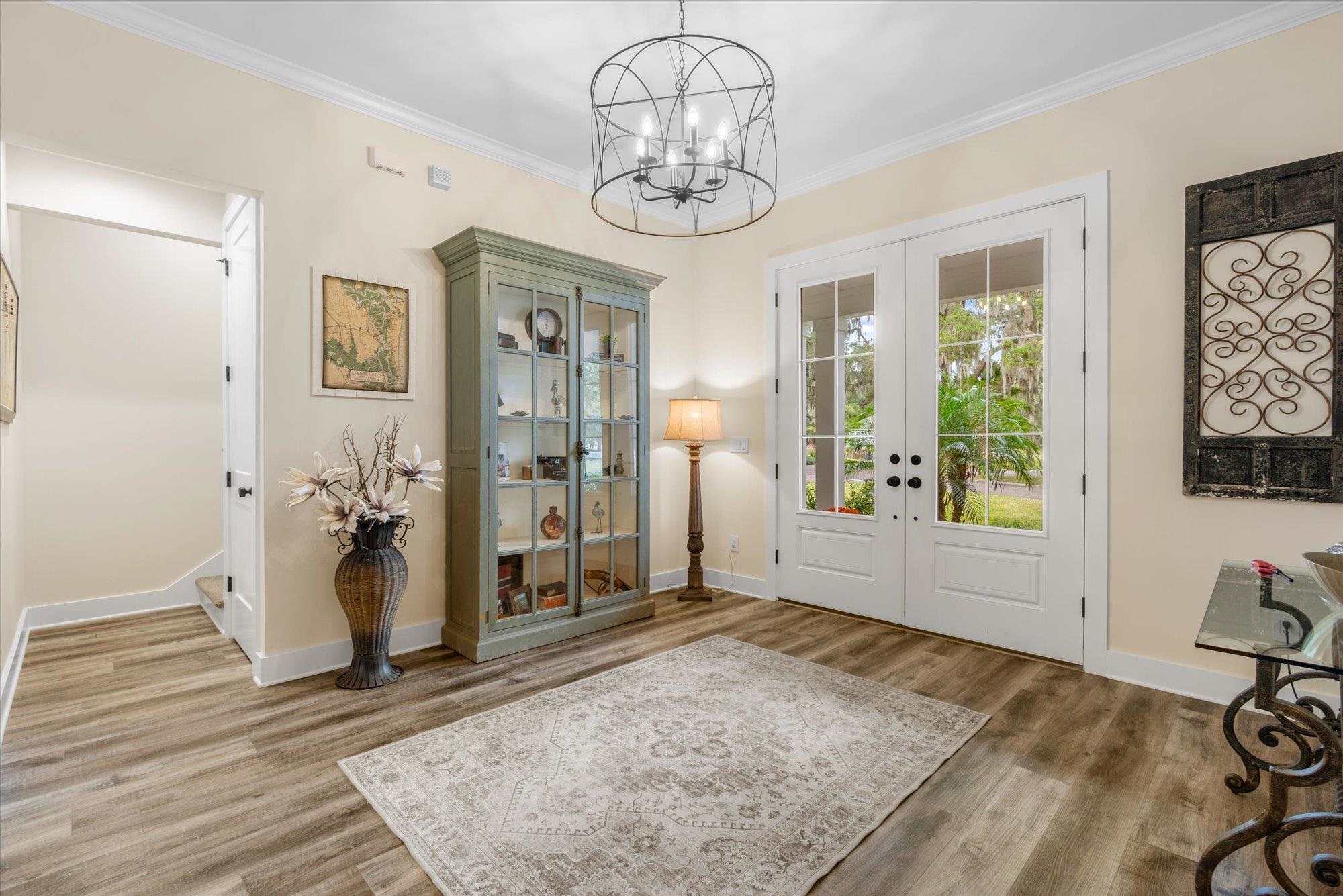 29318 Grandview Manor Yulee, FL 32097 - Photo 13 of 68 a view of a hallway with wooden floor and a chandelier