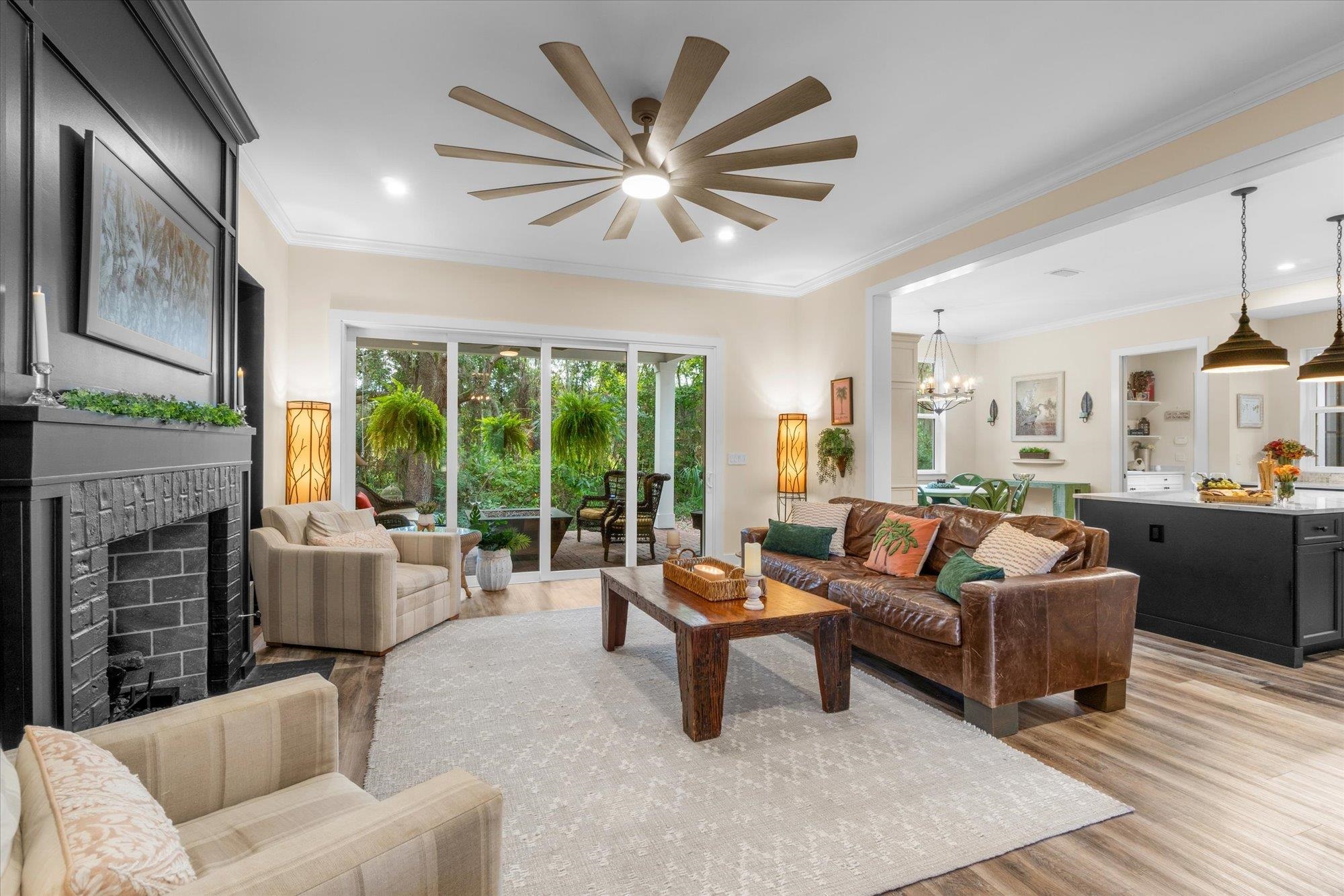 29318 Grandview Manor Yulee, FL 32097 - Photo 15 of 68 Living area with crown molding, a fireplace, light wood-style floors, a chandelier, and recessed lighting