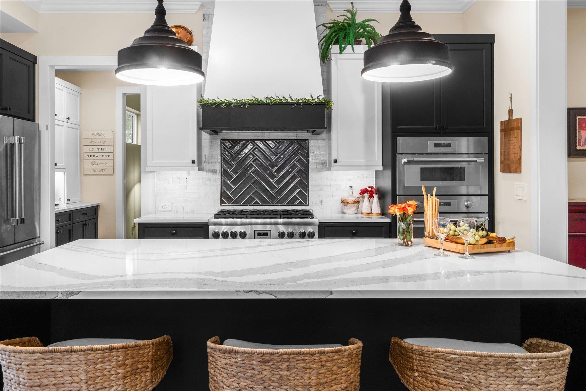 29318 Grandview Manor Yulee, FL 32097 - Photo 17 of 68 Kitchen with a breakfast bar, crown molding, decorative backsplash, and light stone countertops