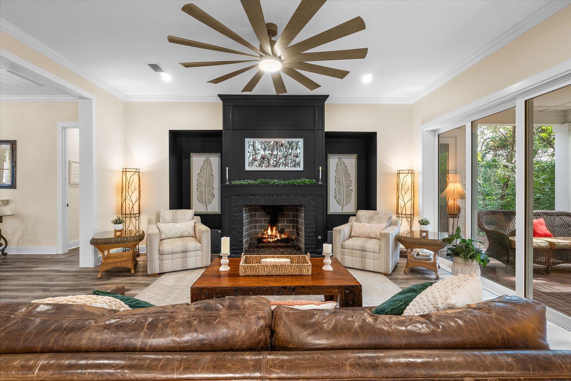 29318 Grandview Manor Yulee, FL 32097 - Photo 3 of 68 Living room with crown molding, a large fireplace, wood finished floors, a ceiling fan, and recessed lighting