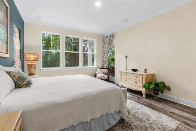 a bedroom with a bed and a lamp on a dresser