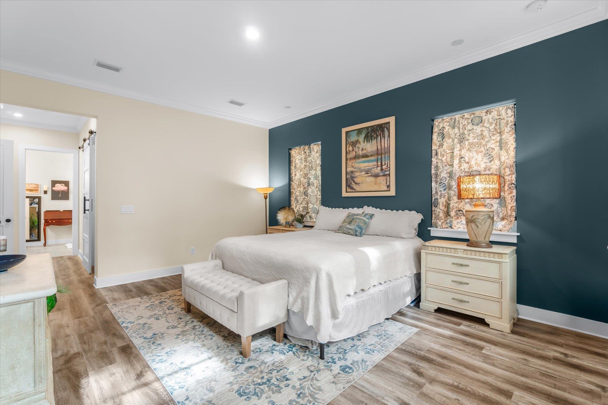 29318 Grandview Manor Yulee, FL 32097 - Photo 33 of 68 Bedroom featuring a barn door, ornamental molding, recessed lighting, and light wood-style floors