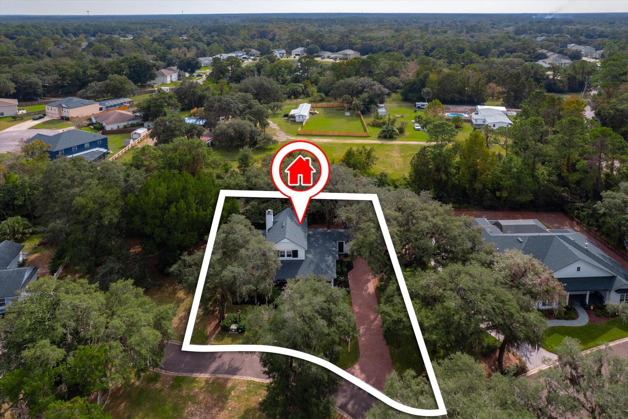 29318 Grandview Manor Yulee, FL 32097 - Photo 45 of 68 Aerial view of residential area featuring property boundaries highlighted and a heavily wooded area